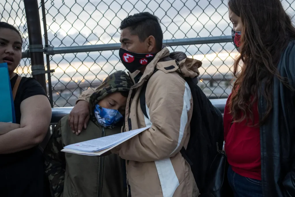 Cesar, 35, an asylum seeker from Nicaragua waits with his wife, Carolina, 25, (Right) and his eight-year-old son Donovan to enter the U.S. port of entry to change their asylum court dates on April 6, 2020, at the Paso del Norte International Bridge in Ciudad Juarez.