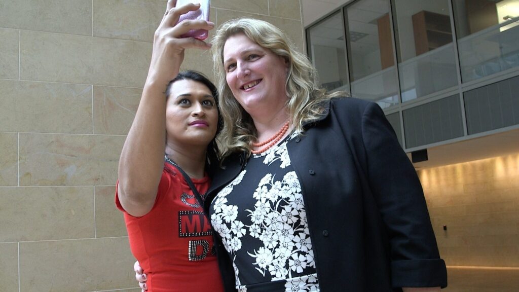 Ava Benach Immigration Attorney with trans refugee client