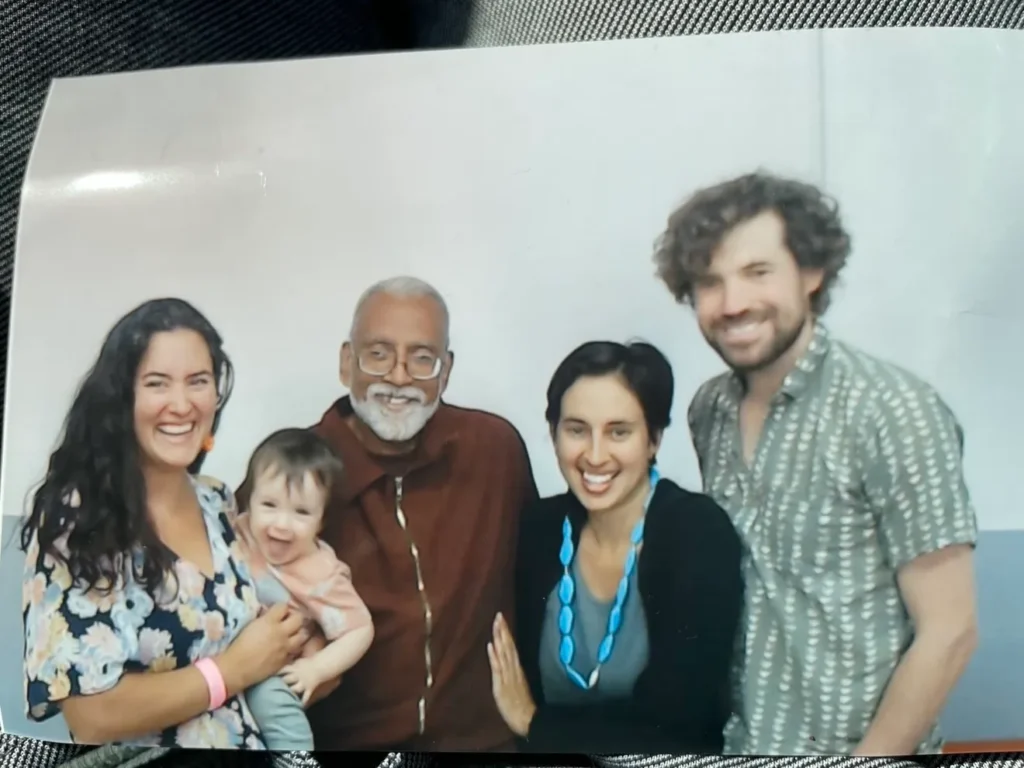Subramanyam “Subu” Vedam, center, while he was in prison, was able to connect with his family, including his nieces Zoë, second from right, and Maya, holding her child, and Maya's partner. After being exonerated, he'd hoped to be freed but is now in ICE custody. Courtesy of Zoë Miller-Vedam